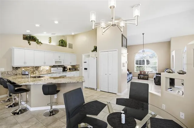 a living room with furniture a fireplace and a table