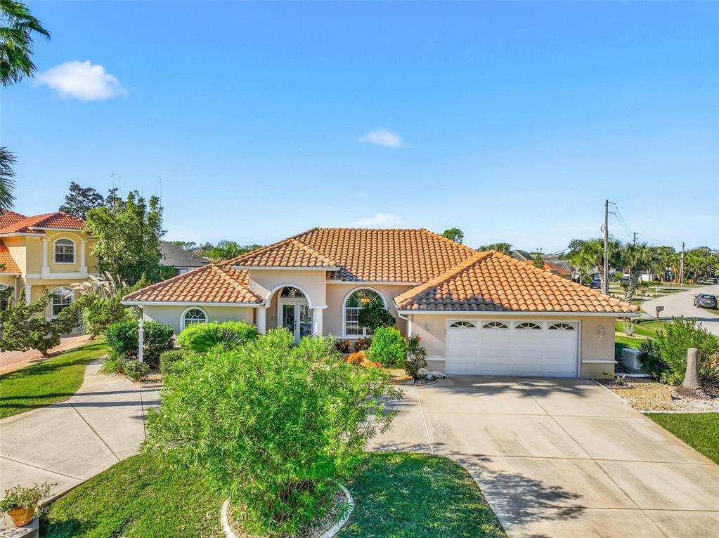 2 Cher Court Palm Coast, FL 32137 - Photo 2 of 64 a front view of a house with a garden
