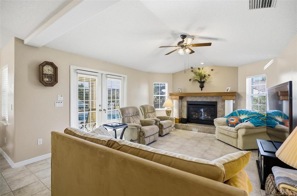 2 Cher Court Palm Coast, FL 32137 - Photo 22 of 64 a living room with furniture a fireplace and a table