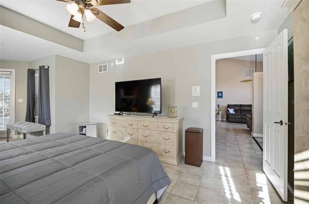 2 Cher Court Palm Coast, FL 32137 - Photo 35 of 64 a bedroom with a bed and a flat screen tv
