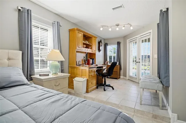 a bedroom with a bed and a chandelier