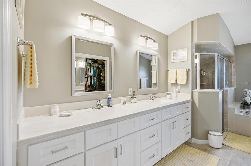 2 Cher Court Palm Coast, FL 32137 - Photo 42 of 64 a bathroom with a double vanity sink and a mirror