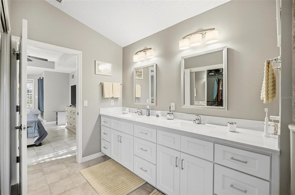 2 Cher Court Palm Coast, FL 32137 - Photo 43 of 64 a spacious en suite bathroom with double sink and a mirror