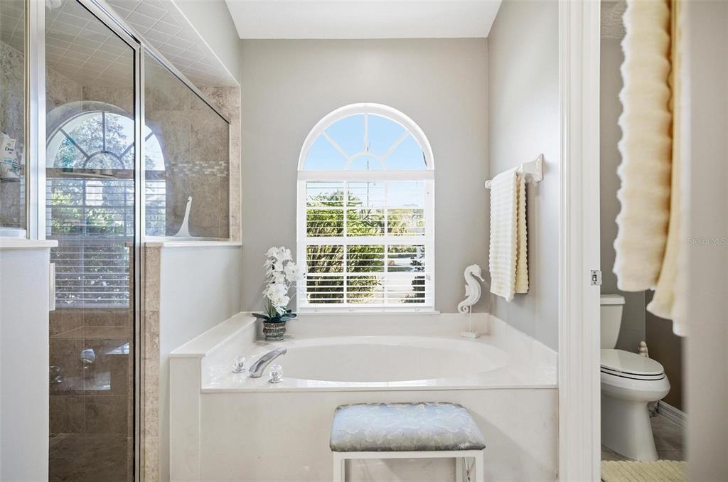 2 Cher Court Palm Coast, FL 32137 - Photo 44 of 64 a bath tub sitting in a bathroom next to a window