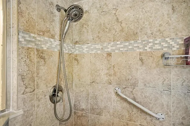 a view of a bedroom with baby bed and windows