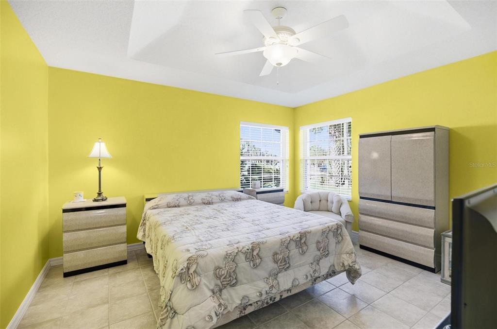 2 Cher Court Palm Coast, FL 32137 - Photo 50 of 64 a bedroom with a bed and a chandelier