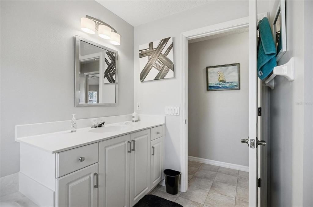 2 Cher Court Palm Coast, FL 32137 - Photo 53 of 64 a spacious bathroom with a double vanity sink and a mirror