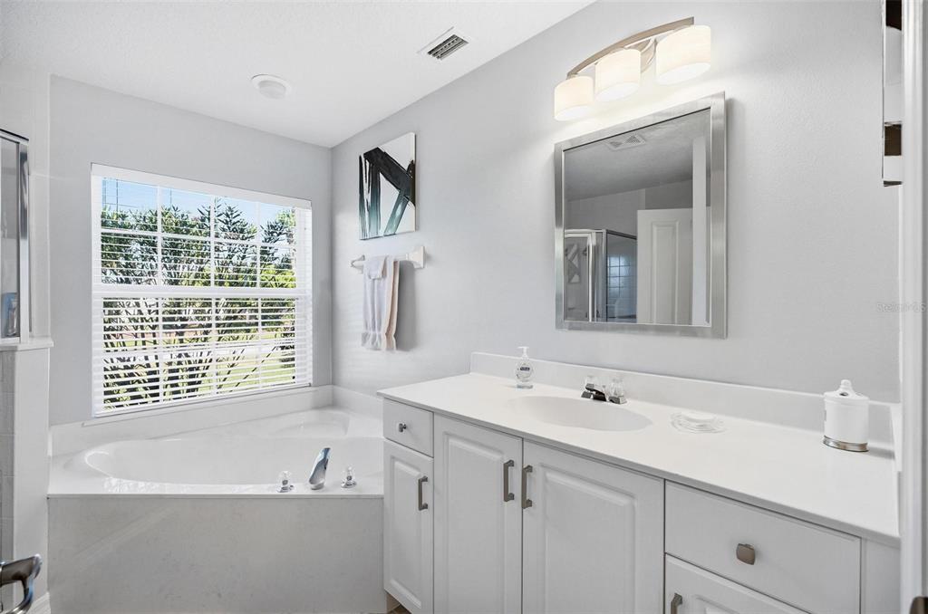 2 Cher Court Palm Coast, FL 32137 - Photo 54 of 64 a bathroom with a tub a sink and mirror