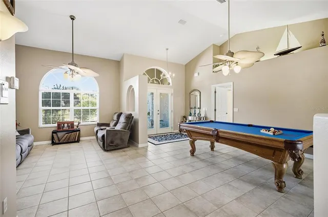 a living room with furniture a chandelier and a window