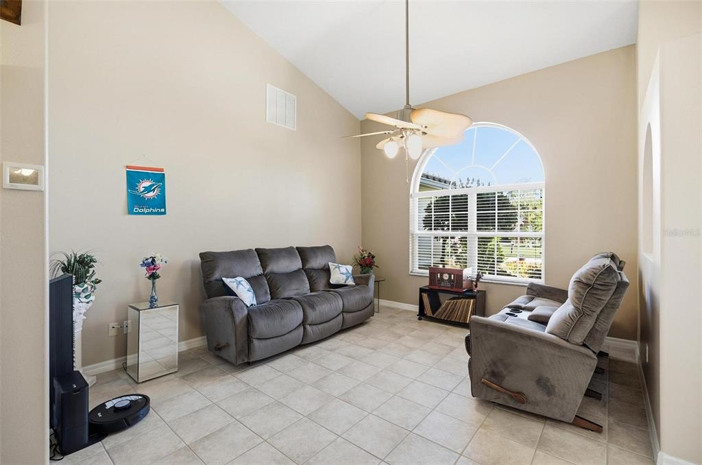2 Cher Court Palm Coast, FL 32137 - Photo 10 of 64 a living room with furniture a chandelier and a window