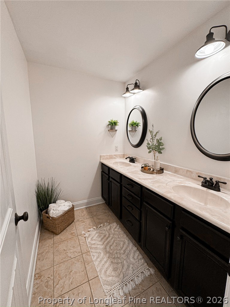 93 Falcon Ridge Drive Spring Lake, NC 28390 - Photo 33 of 50 a bathroom with a double vanity sink and a mirror
