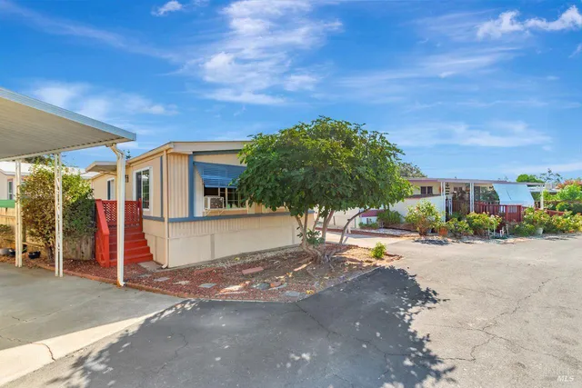 a view of a street with a house in the background