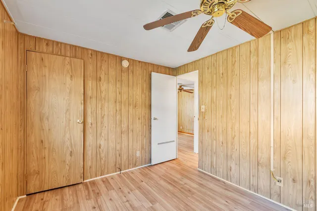 a view of a room with a window and a ceiling fan