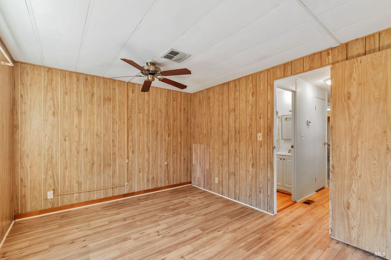 504 Colonial Park Drive Santa Rosa, CA 95403 - Photo 15 of 22 a view of a room with wooden floor and a ceiling fan
