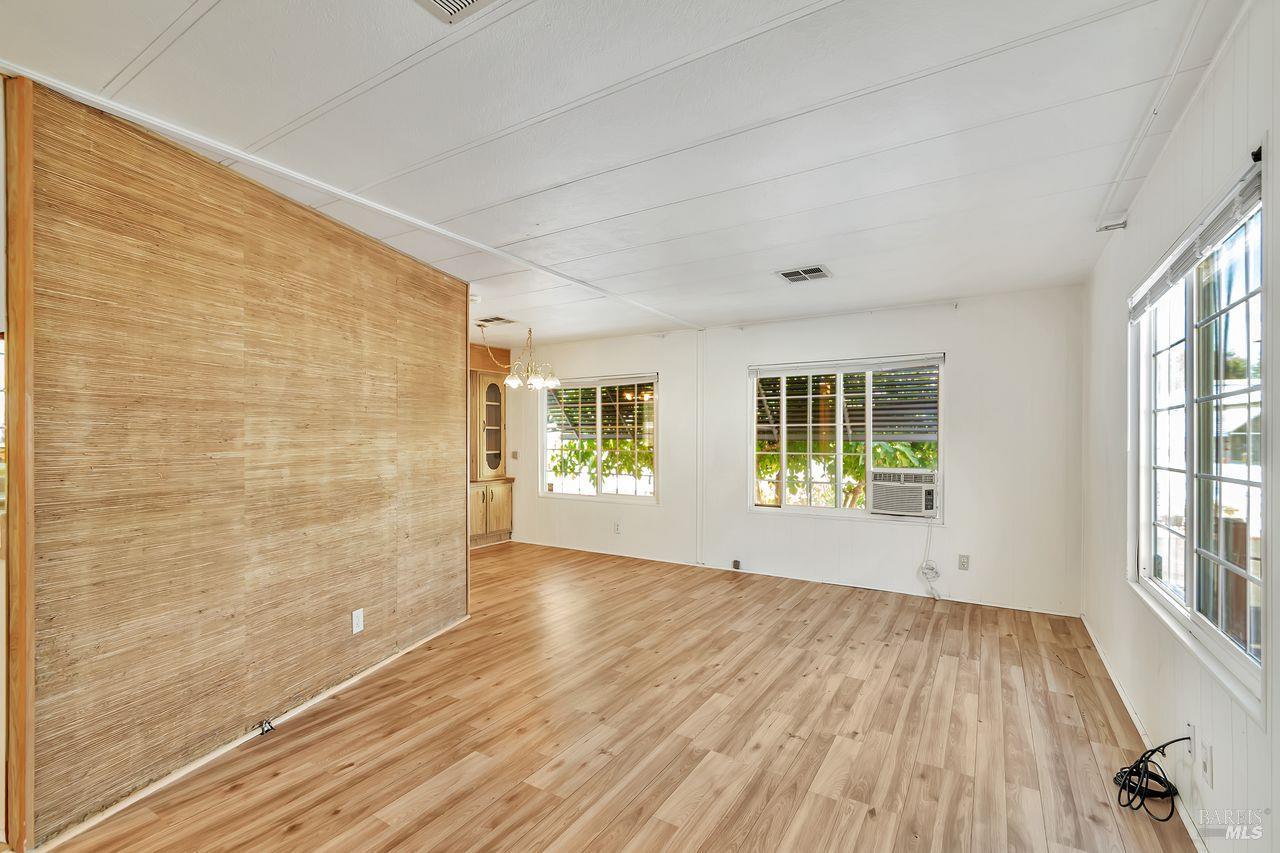 504 Colonial Park Drive Santa Rosa, CA 95403 - Photo 5 of 22 a view of empty room with wooden floor and fan