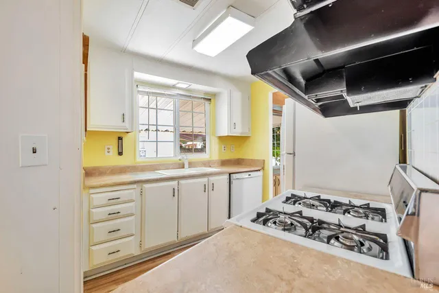 a kitchen with a stove a sink and a refrigerator