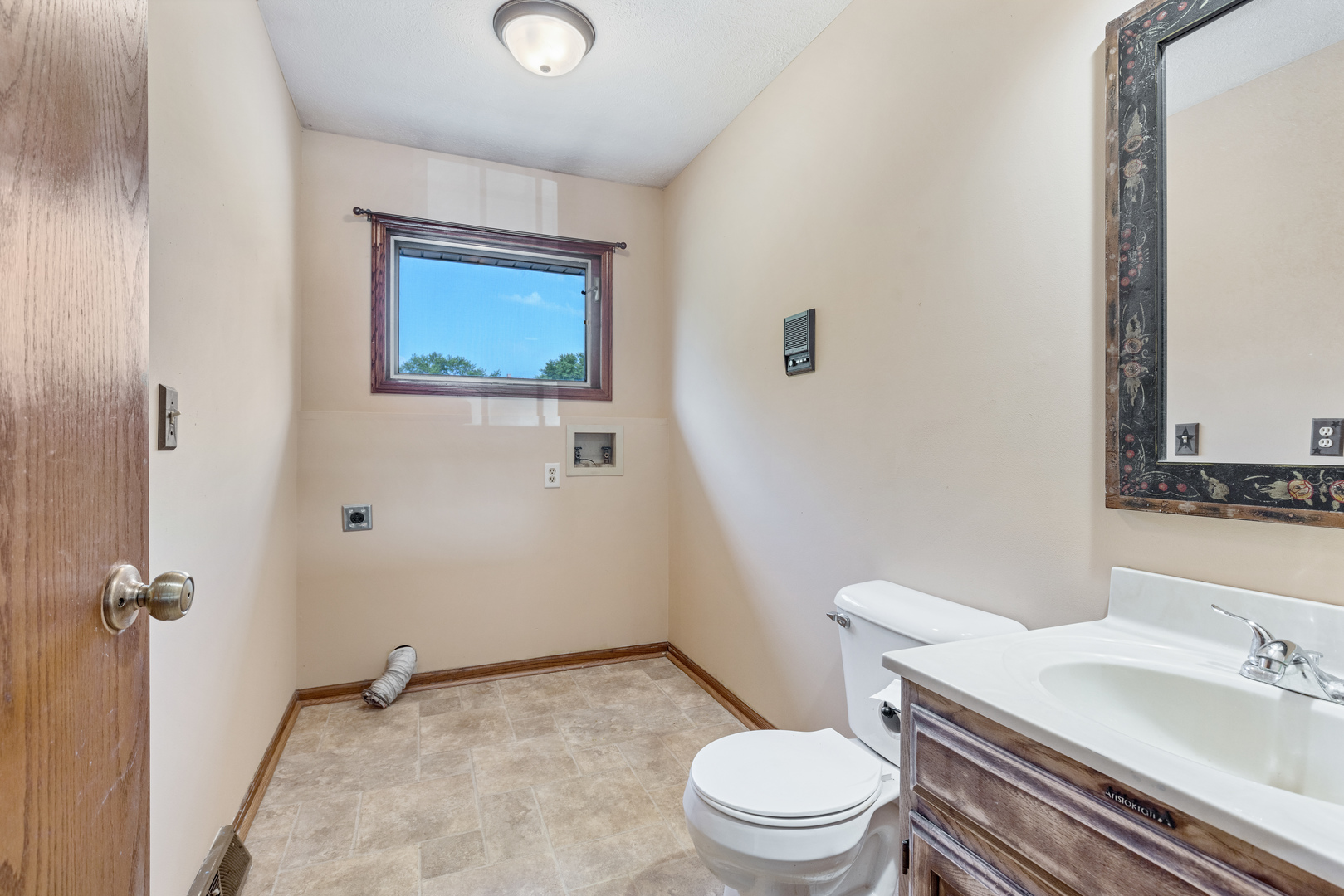 5394 South Mill Pond Road Rochelle, IL 61068 - Photo 13 of 28 a white toilet sitting next to a bathroom sink