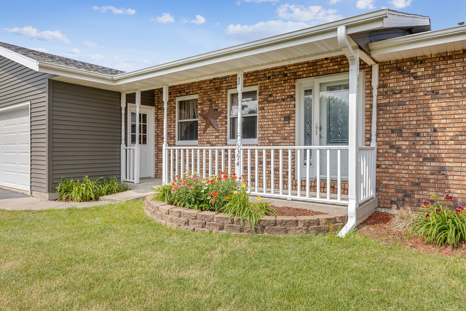 5394 South Mill Pond Road Rochelle, IL 61068 - Photo 2 of 28 a front view of a house with a garden