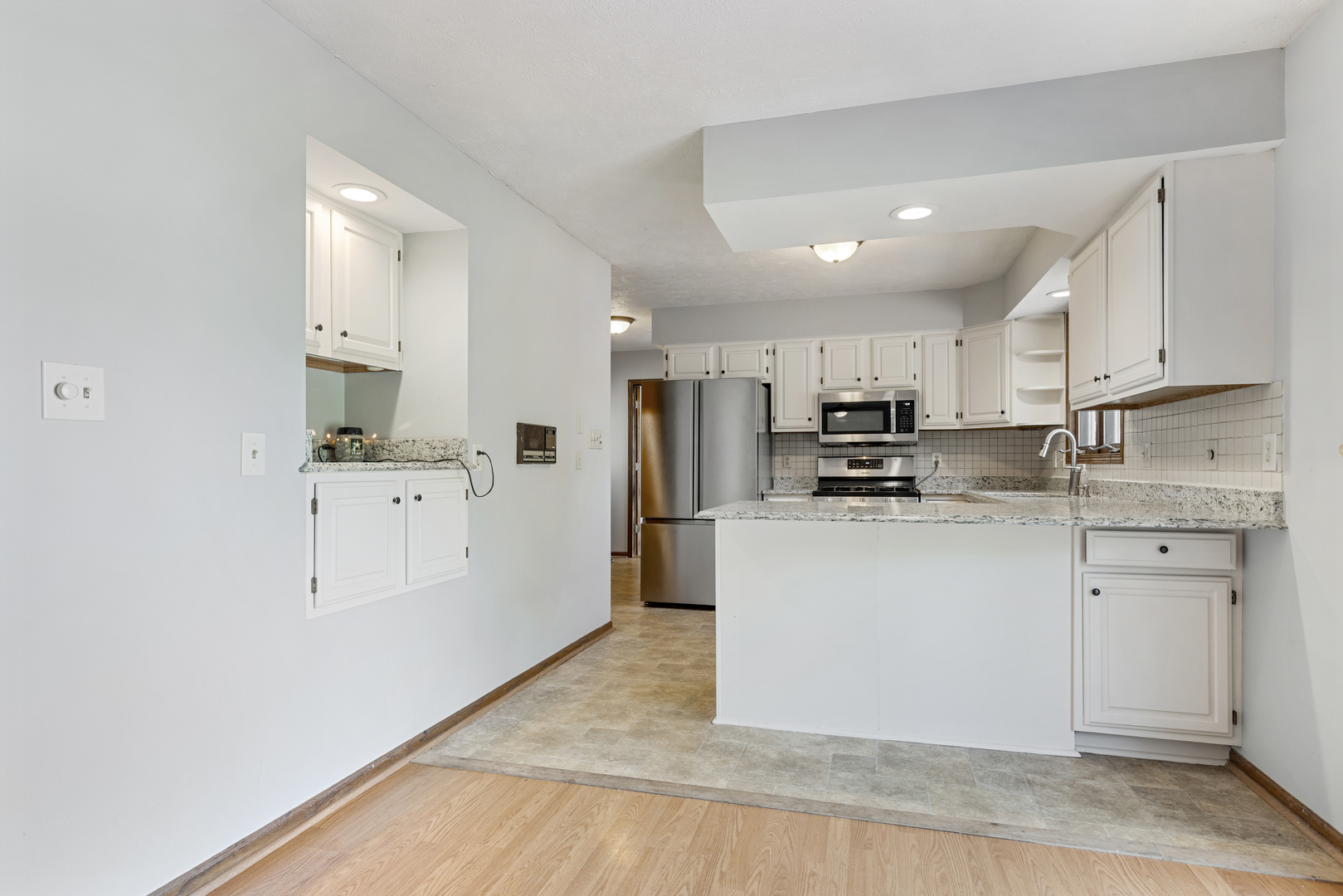 5394 South Mill Pond Road Rochelle, IL 61068 - Photo 5 of 28 a kitchen with white cabinets and stainless steel appliances