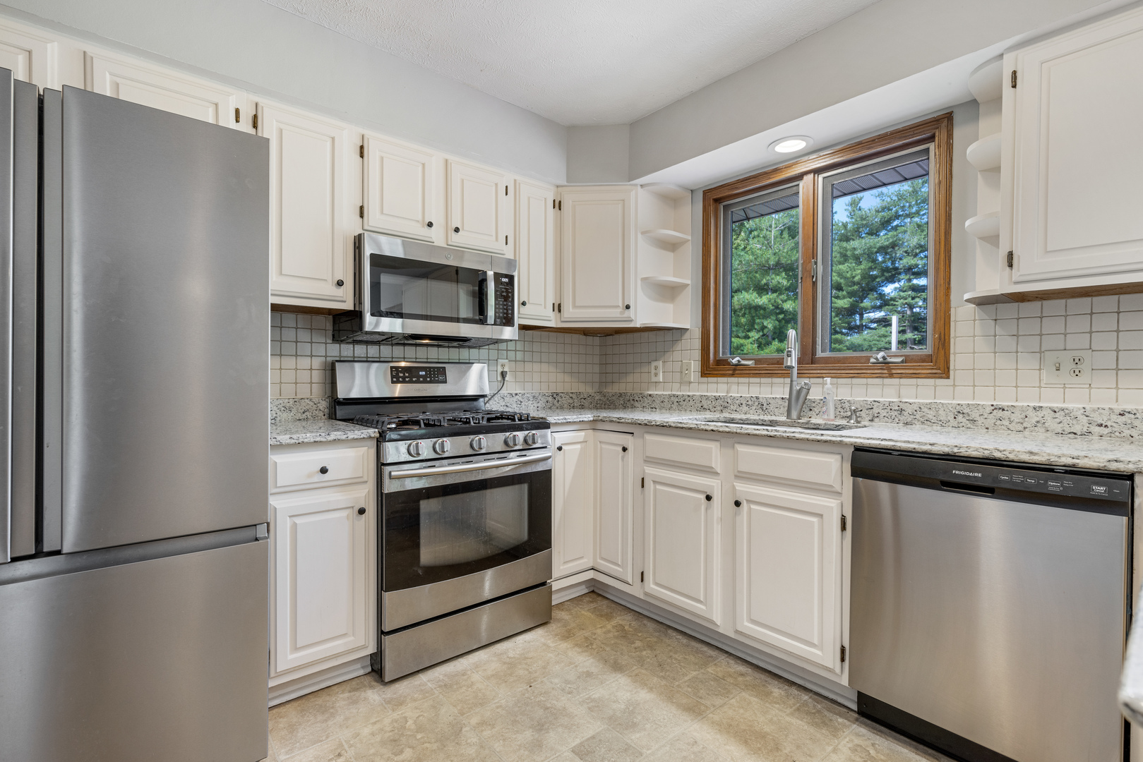 5394 South Mill Pond Road Rochelle, IL 61068 - Photo 7 of 28 a kitchen with cabinets stainless steel appliances and window