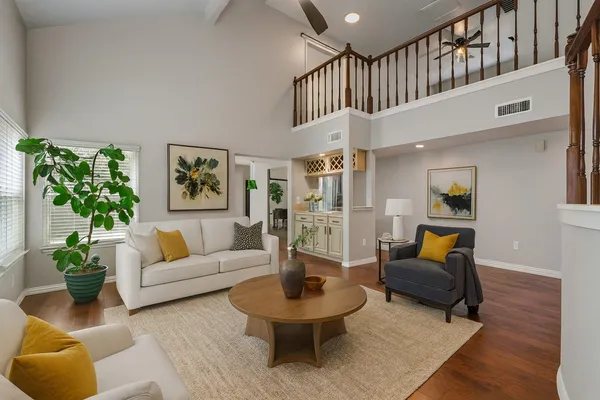 a living room with furniture a rug and a large window