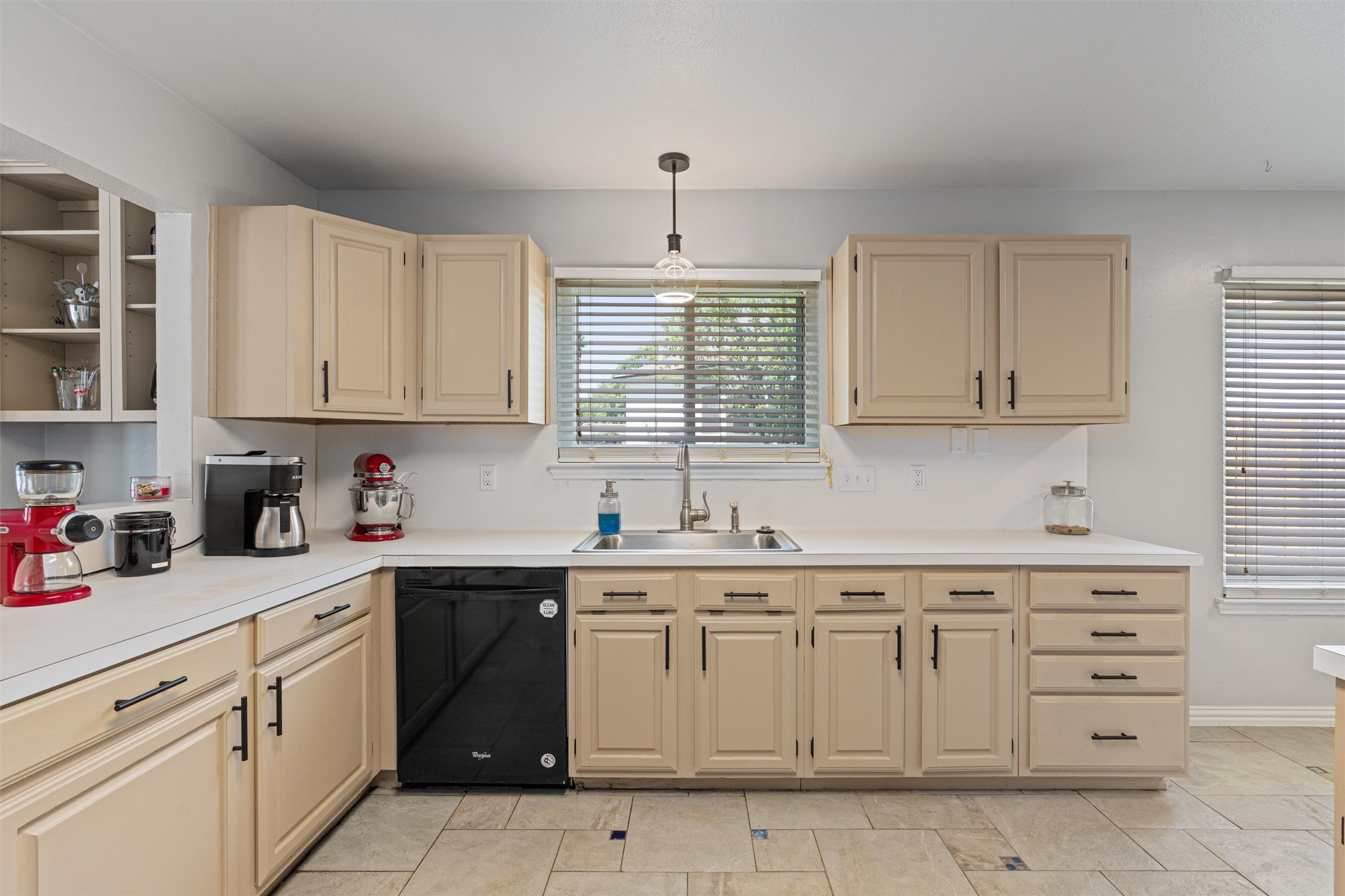 3011 Wadsworth Way Austin, TX 78748 - Photo 12 of 28 a kitchen with cabinets appliances a sink and a window