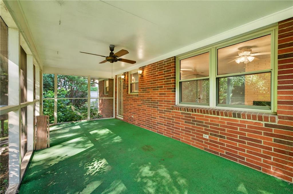 113 Green Valley Road Greensboro, NC 27403 - Photo 34 of 46 This spacious screened porch extends your living space outdoors—perfect for morning coffee, evening conversations, or simply enjoying the peaceful surroundings.