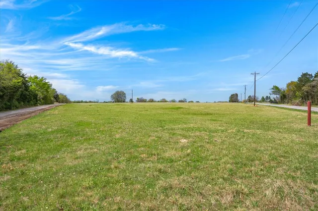 a view of a field with an ocean