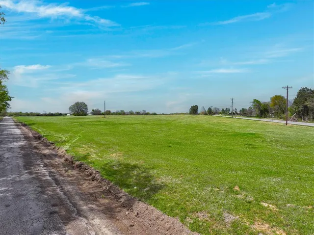 a view of a field with an trees