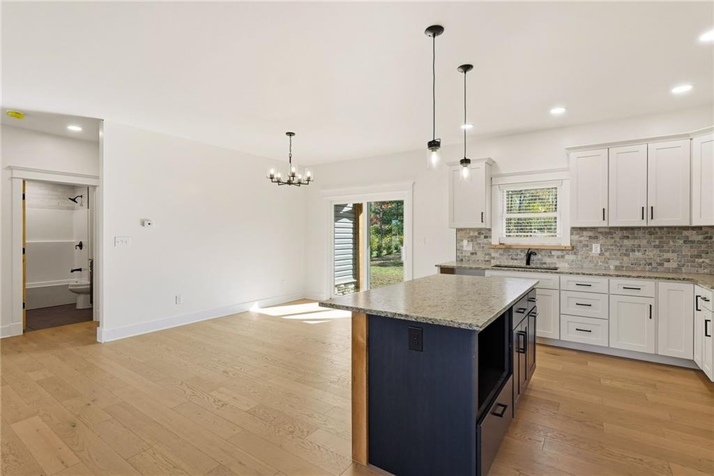4844 Lucerne Road Indiana, PA 15701 - Photo 15 of 39 a kitchen with kitchen island granite countertop a stove a sink a center island and cabinets