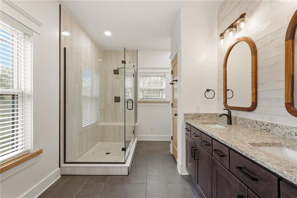 4844 Lucerne Road Indiana, PA 15701 - Photo 20 of 39 a bathroom with a granite countertop sink a mirror and a shower