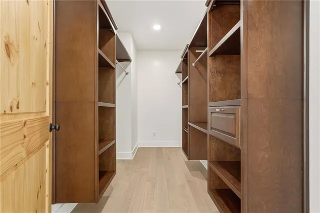 a view of walk in closet with empty racks