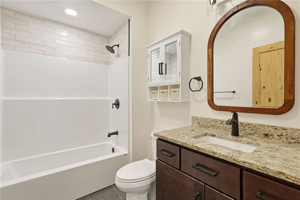 4844 Lucerne Road Indiana, PA 15701 - Photo 28 of 39 a bathroom with a granite countertop sink a toilet and a mirror