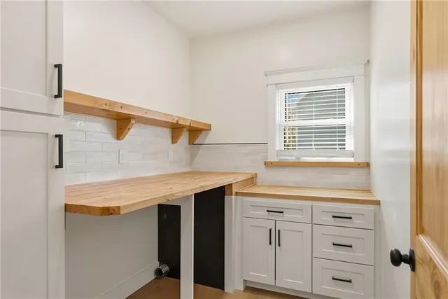 a kitchen with a sink stove and cabinets