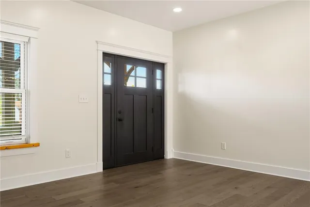 an empty room with wooden floor and closet