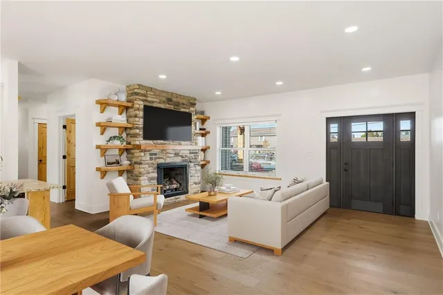 a living room with furniture a fireplace and a flat screen tv