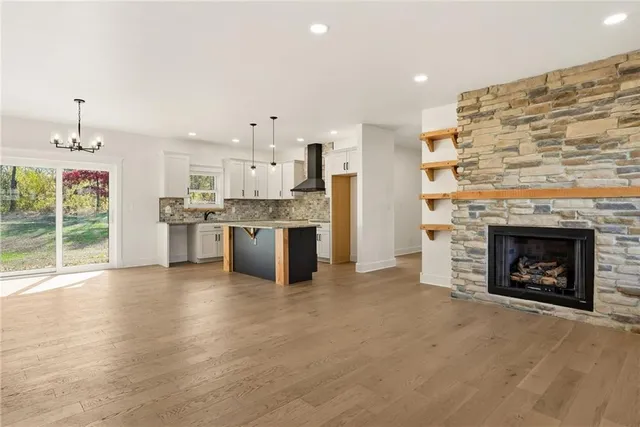 a view of a kitchen with a stove cabinets and a fireplace