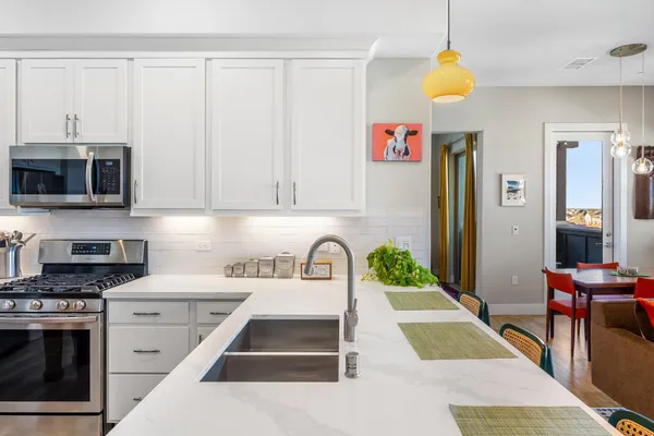 a kitchen that has a table and chairs in it