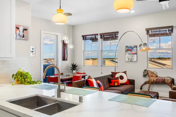 a living room with furniture a flat screen tv and a window