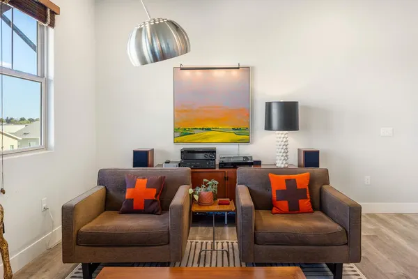 a blue couch sitting in a living room next to a window