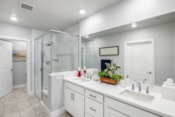 a bathroom with a shower a toilet and a sink