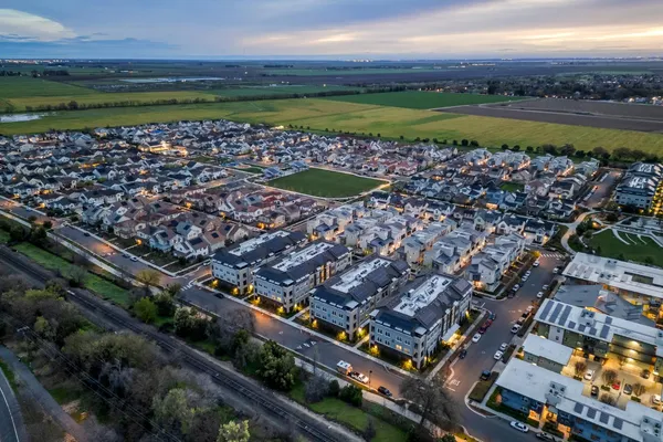 an aerial view of a residential houses with outdoor space