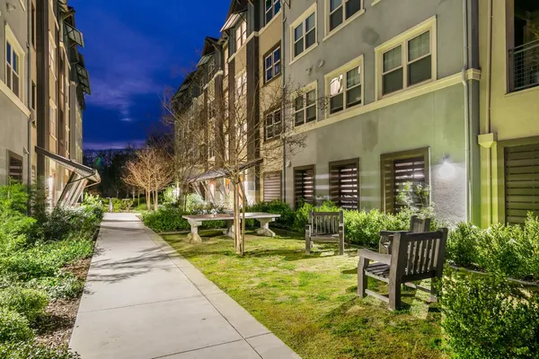 a view of a patio with a table and chairs and potted plants