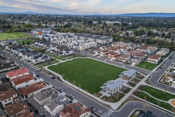 an aerial view of a residential building and an ocean