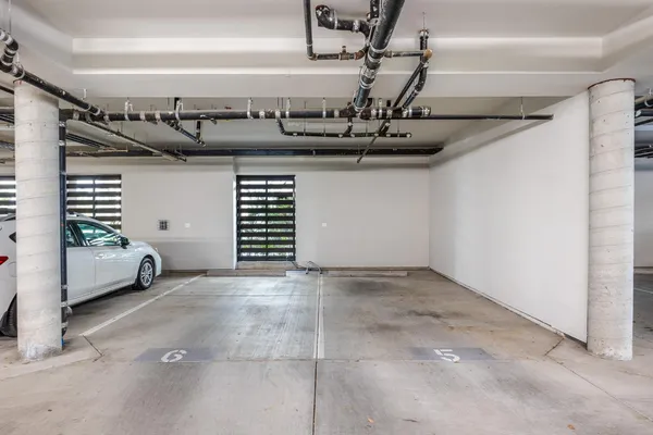 a living room with furniture kitchen view and a chandelier