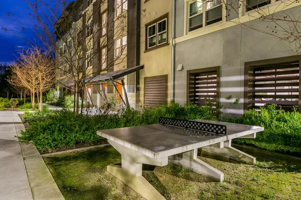 a view of a brick house with large windows