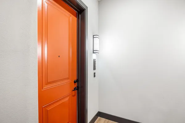 a kitchen with stainless steel appliances granite countertop a stove top oven a sink dishwasher a dining table and chairs with wooden floor