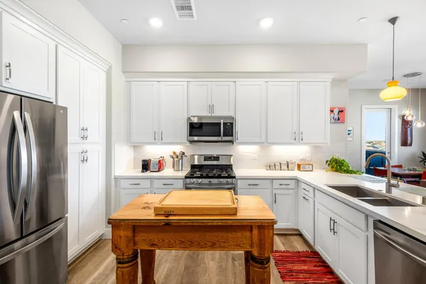 a stove top oven sitting inside of a kitchen