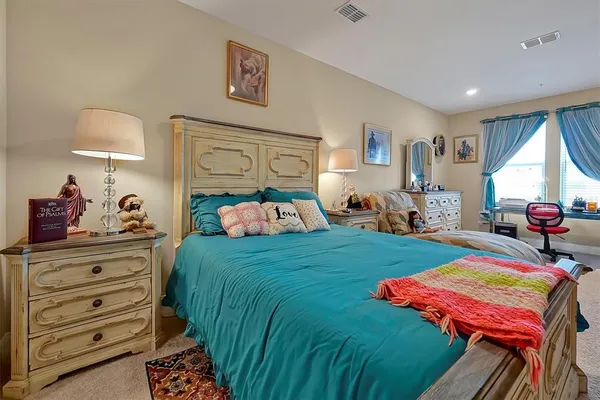 a bed room with a bed window and a dresser