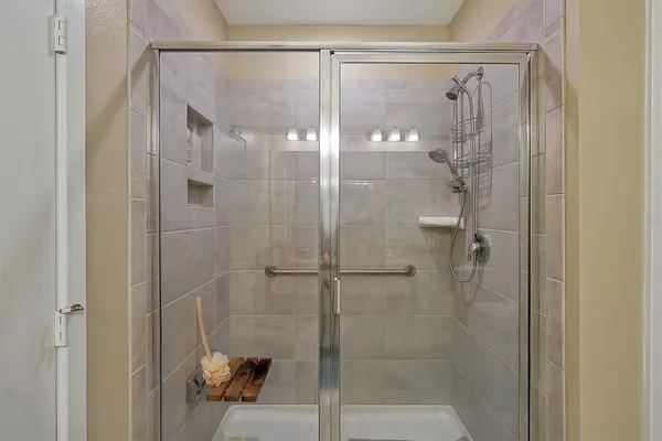 a bathroom with a glass shower door